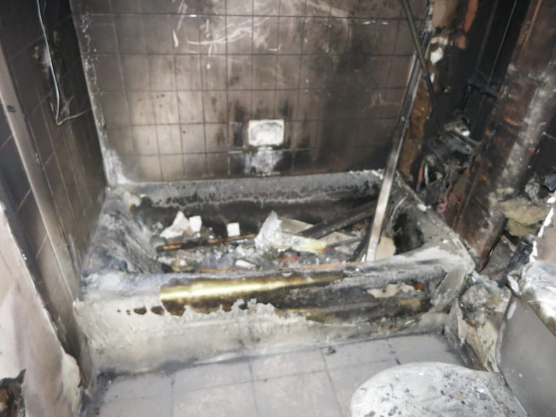 Fire damaged bathroom before smoke and soot restoration